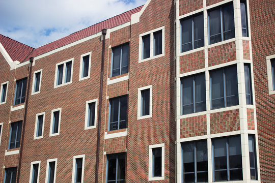 Architecture brick university building with glass windows and white frames