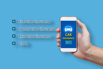 Car insurance concept and man hand holding smartphone.