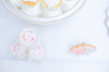 The dessert table has cream cakes, cookies, pudding