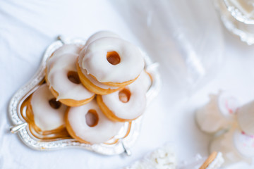 The dessert table has cream cakes, cookies, pudding