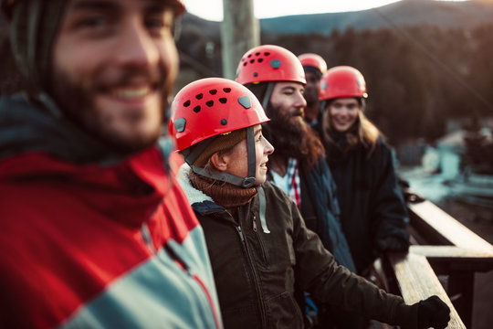A group of friends enjoy the outdoor views from a deck while zip lining in upstate New York