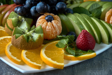 Naklejka na ściany i meble fruit plate. Glass bank of lemonade with sliced citrus fruits on a buffet table