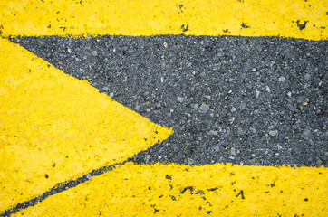 close up to a yellow arrow in the direction to the right, close up to yellow pedestrian crossing with an arrow