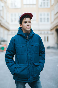 Portrait of a boy  with a blurred street in the background