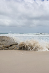 Wave crashing on the beach at Little Oberon Bay, Wilsons Promontory, Victoria, Australia.