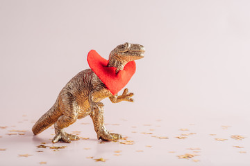 Silly dino with a golden heart around his neck
