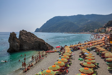People swimming and sunbathing on the beach at Monterosso al Mare on the Ligurian coast, Italy