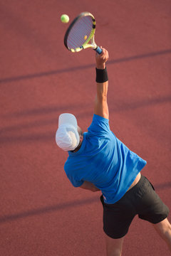 Male tennis player stroking the ball