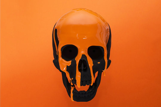 Black Skull with dripping orange paint