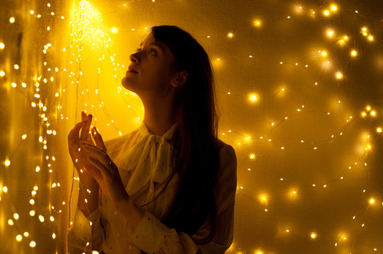 Silhouette of a woman surrounded by lights