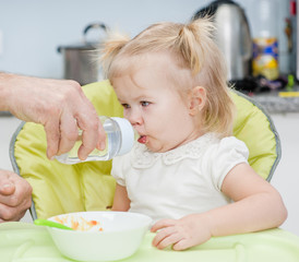 Father gives daughter drink water bottles