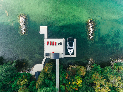 Overhead drone image of a boathouse on a lake