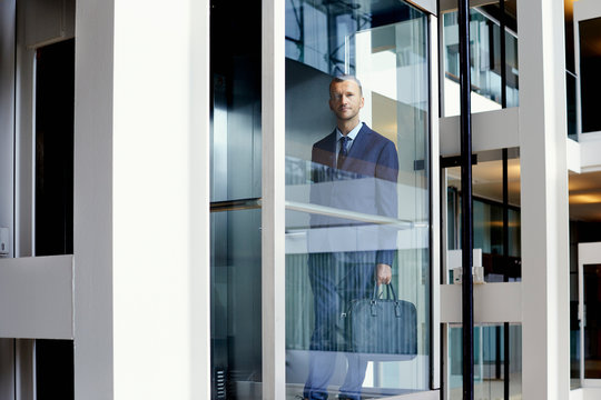 Portrait Of Businessman Standing In Elevator