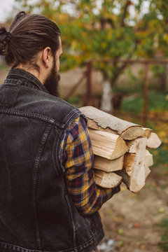 man carries wood pieces