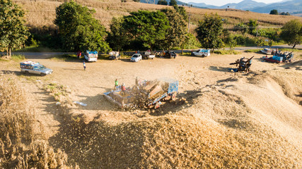 Fototapeta na wymiar Transport of Traditional Combine Operator Harvesting Corn on the Field in Summer Evening at North of Thailand