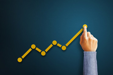 Businessman is touching arrows pointing up with graph as a symbol of growth and success or rising successful development and business development in the future