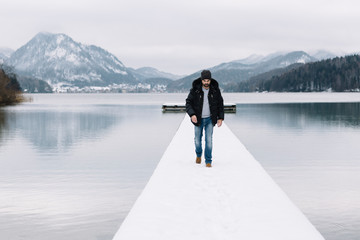 Man standing on snowy dock