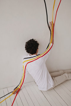 Conceptual portrait with man taped to wall and floor
