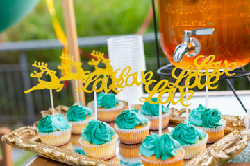 Colorful cream cakes, cookies, donuts on dessert tables.