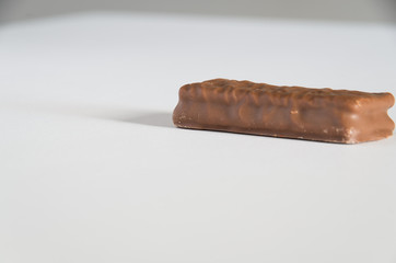 Chocolate biscuit on a white bench
