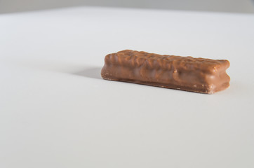 Chocolate biscuit on a white bench