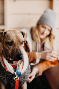 Woman Sitting at a Brewery with her Dog