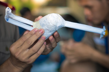 Students learn to make paper mache art as a giraffe in school.