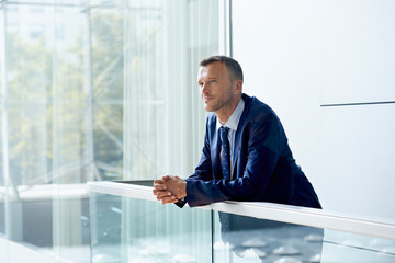 Portrait Of Businessman Leaning On Railing