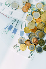 Paper currency notes and coins euros, white background