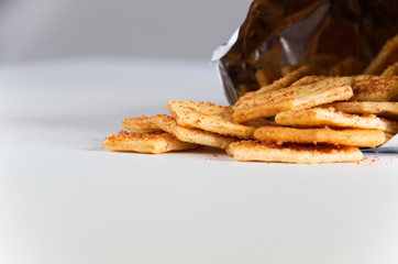 Flavoured biscuits spilling out of the packaging onto a white bench