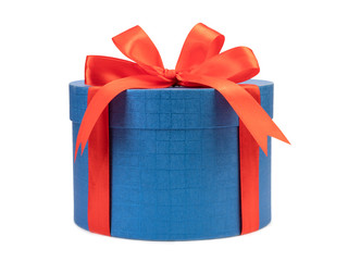 Round blue gift box with red bow on a white background