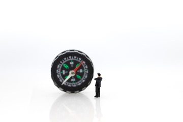 Miniature people : businessman standing with compass. Image use for business concept.