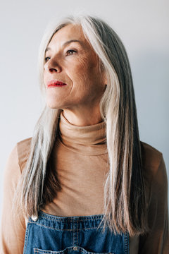Portrait of a senior woman with grey long hair.