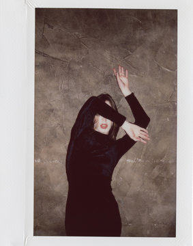 young androgyne man in small black dress dancing