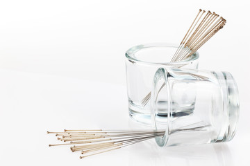 Silver needles for traditional Chinese acupuncture medicine. White background. Full depth of fieldm.