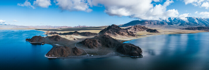 panoramashot of a camping truck on the shore of an alpine mongolian peninsula