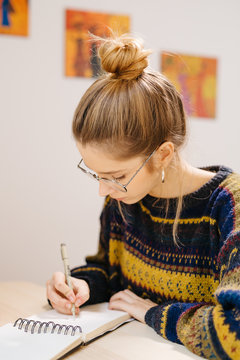 Woman drawing in sketchbook