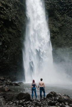Couple standing near waterfall