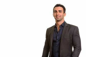 Portrait of young happy Persian businessman against white background