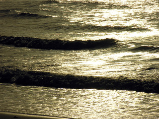 sea waves with sun reflecting