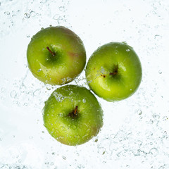 Green apples with water splash