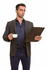 Persian businessman with clipboard and coffee cup