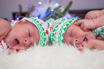 Little newborn baby boys, twin brothers. Christmas costume