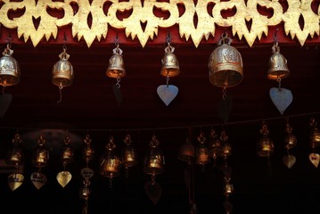 Row of golden bells in Buddhist temple in Chiang Mai, Thailand.