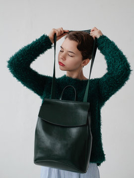 Stylish woman with emerald bag