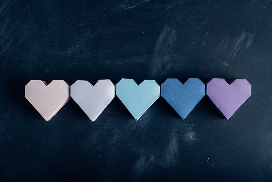 Colored paper hearts in a row