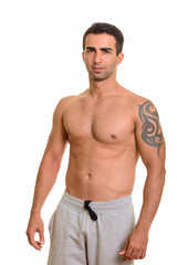 Portrait of young handsome Persian man shirtless