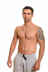 Fototapeta premium Portrait of young handsome Persian man shirtless