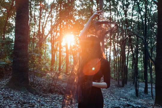 Asian woman with halloween makeup in forest