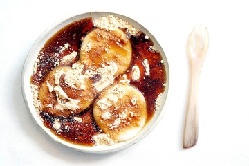 Warabi mochi is a jelly-like confection made from bracken starch and covered or dipped in kinako (sweet toasted soybean flour) and drizzled with kuromitsu(black sugar syrup). 